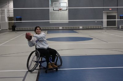 Student participating in wheelchair football at an adaptive intramural sports event.